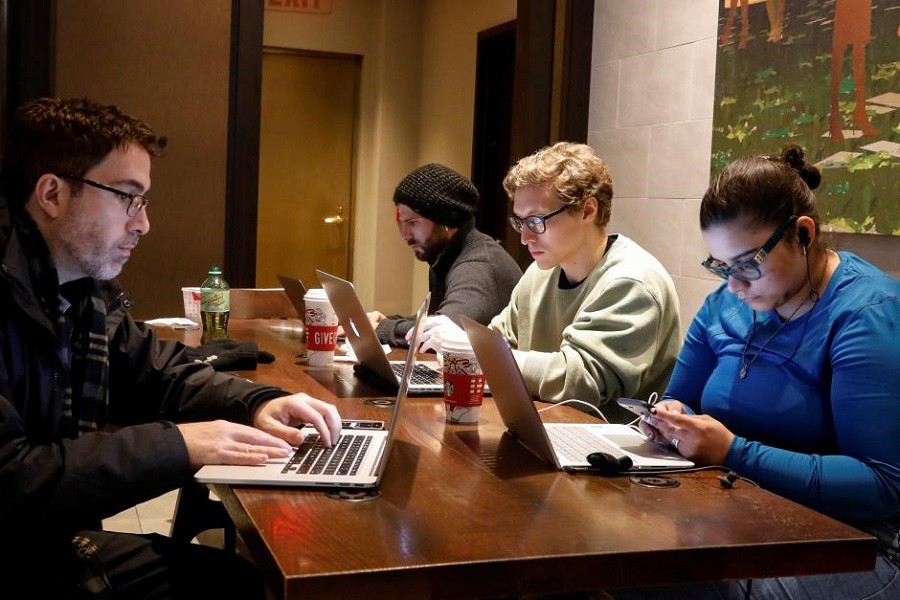 Customers use the internet at a Starbucks in the financial district in New York City, US, December 14, 2017. Reuters