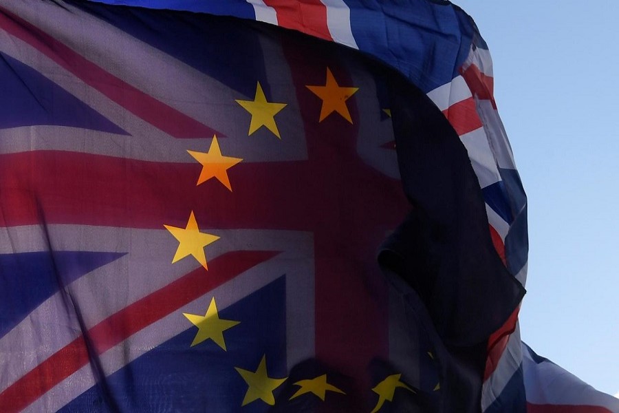 An EU flag and Union flag are seen flying together during an anti-Brexit protest near the Houses of Parliament in London, Britain, December 8, 2017. Reuters