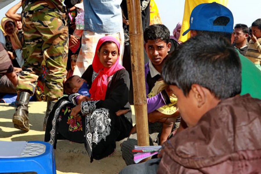 Newly-arrived Rohingya people wait at an army camp in Sabrang of Teknaf on Nov. 29 last before being shifted to a camp in Cox's Bazar.	— Farid Ahmed/IPS