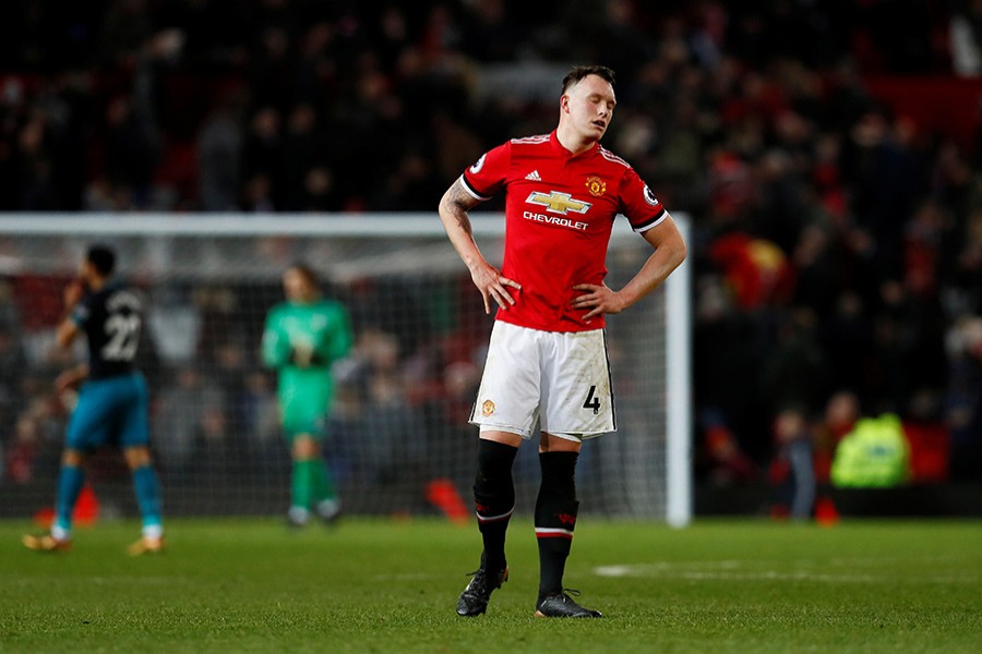 Manchester United's Phil Jones cuts a dejected figure after the match. - Reuters photo