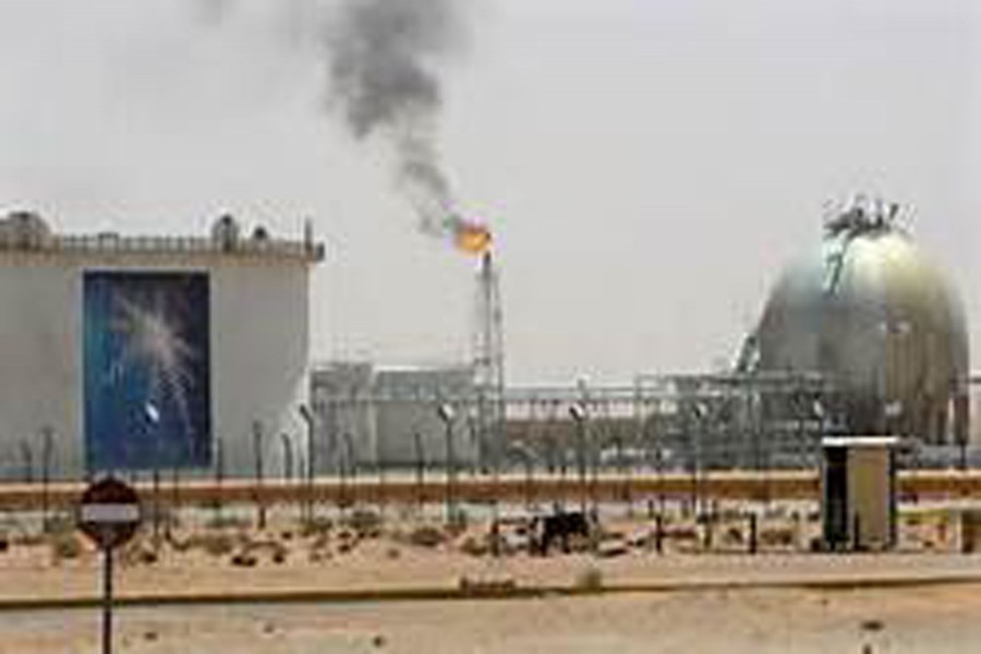 A gas flame is seen in the desert near the Khurais oilfield, Saudi Arabia. 	—Reuters