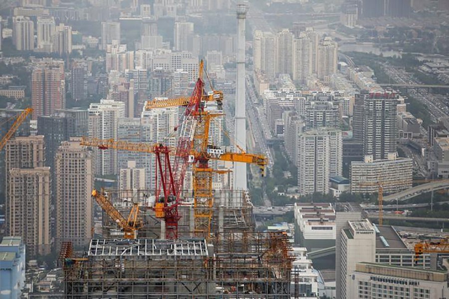 Cranes are seen on top of a skyscraper that is under construction in Beijing, China August 26, 2017. - Reuters file photo used for representation.