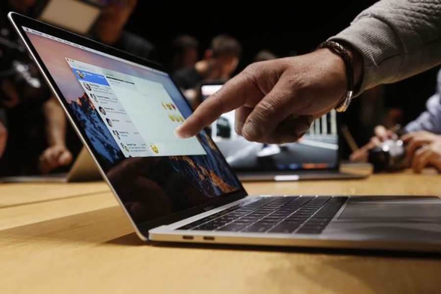 A guest points to a new MacBook Pro during an Apple media event in Cupertino, California, US October 27, 2016. - Reuters file photo