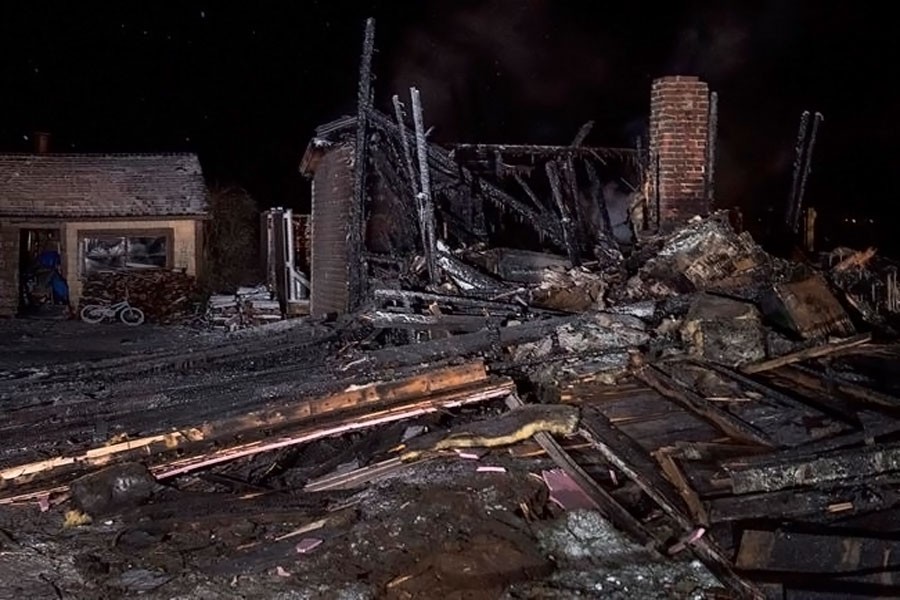 The remains of a house destroyed in an early morning fire are seen in Pubnico Head, Nova Scotia on Sunday, Jan 7, 2018. (Internet photo)