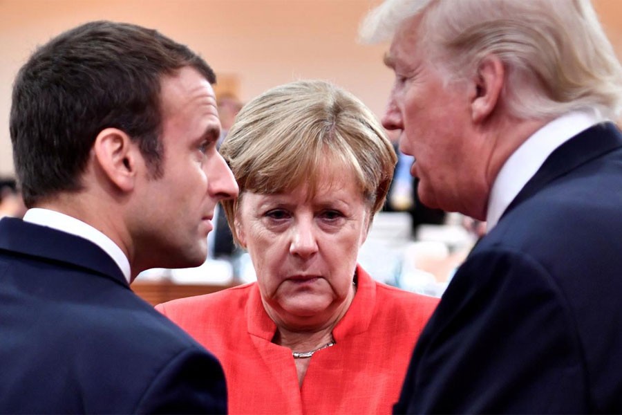 French President Emmanuel Macron, German Chancellor Angela Merkel and US President Donald Trump confer at the start of the first working session of the G20 meeting in Hamburg, Germany, July 7, 2017. (REUTERS)