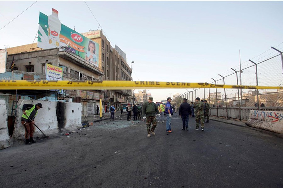 Iraqi security forces inspect the site of a bomb attack in Baghdad, Iraq on Monday. - Reuters photo