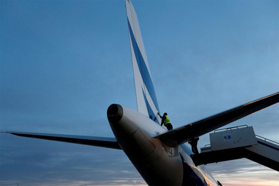 A man inspects a plane damaged during clashes at Mitiga airport in Tripoli, Libya, January 15, 2018. (REUTERS)