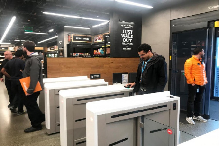 A shopper scans a smartphone app associated with his Amazon account and credit card information to enter the Amazon Go store in Seattle on Thursday. - Reuters photo