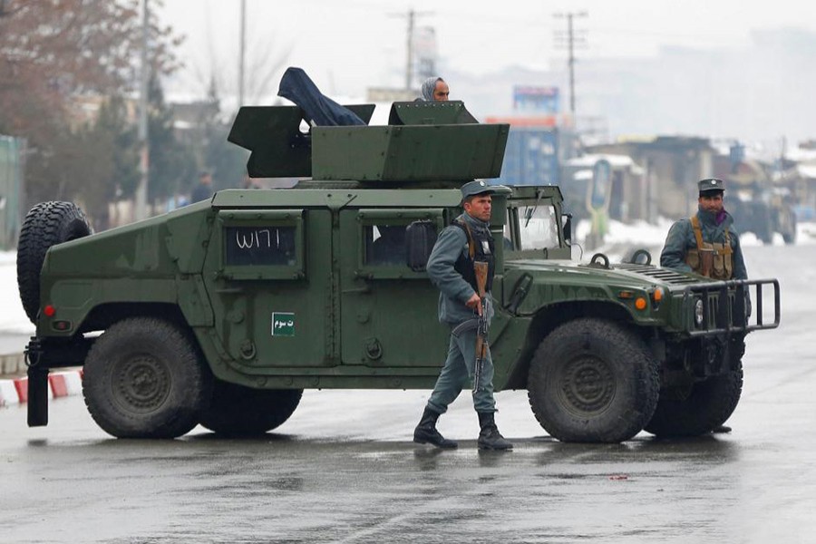 Afghan policemen keep watch near the site of an attack at the Marshal Fahim military academy in Kabul, Afghanistan on Monday. - Reuters photo