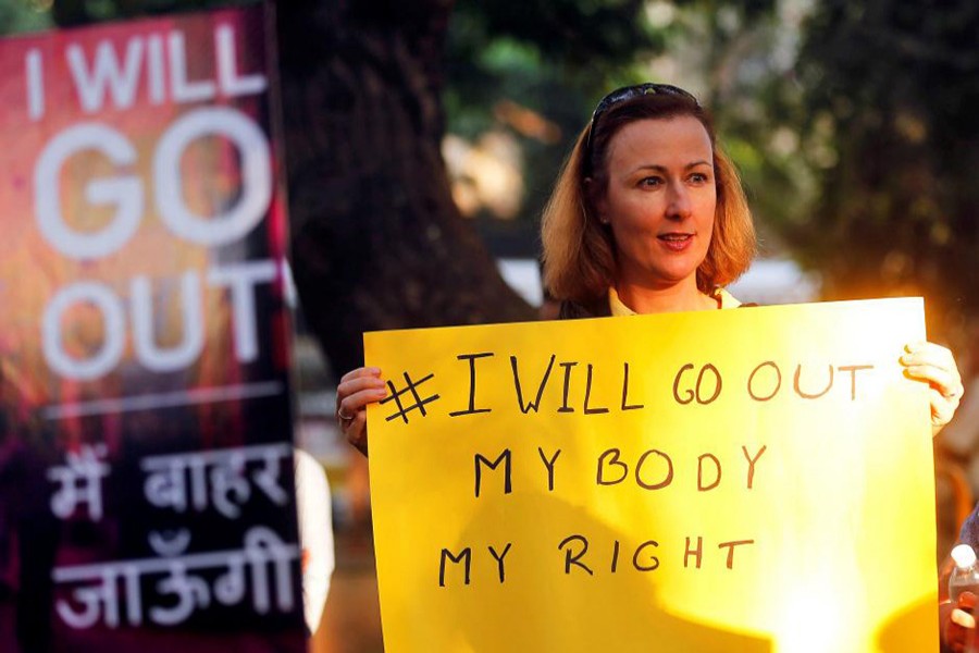 A woman holds a sign as she takes part in the #IWillGoOut rally, to show solidarity with the Women's March in Washington, along a street in Mumbai, India, January 21, 2017. - Reuters file photo