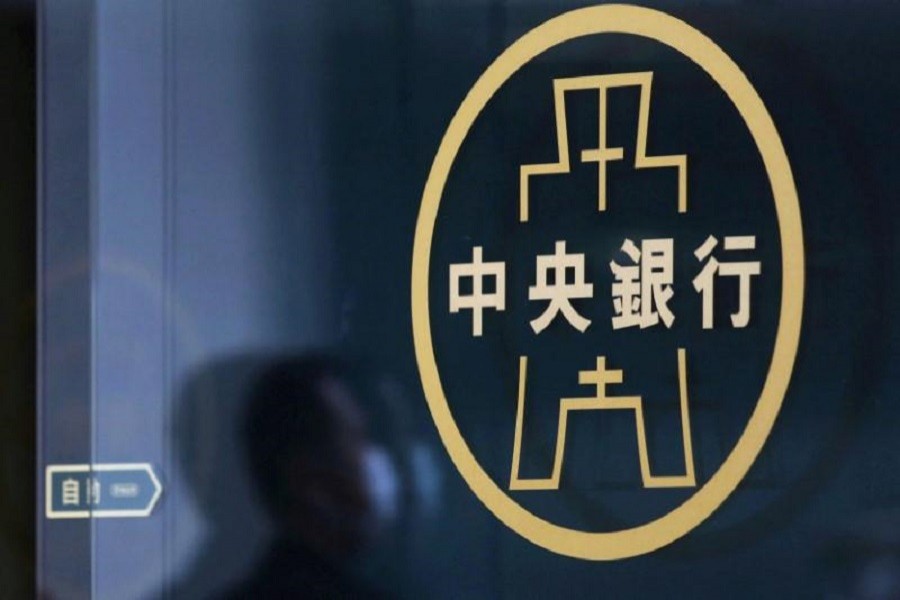 A man is seen reflected next of the Taiwan's Central Bank logo in Taipei, Taiwan March 24, 2016. Reuters/File Photo