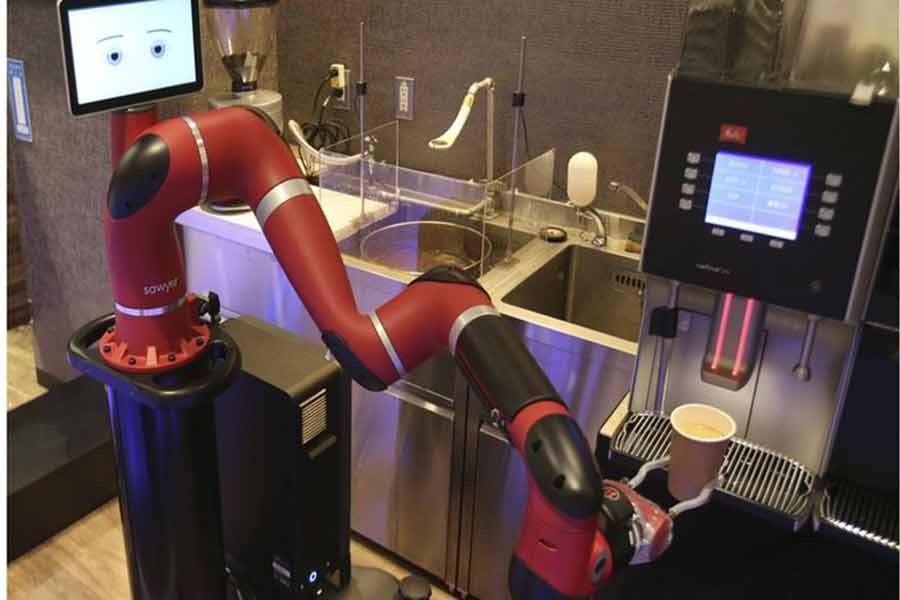 Robot barista named “Sawyer” makes a coffee at Henn-na Cafe, meaning “Strange Cafe” in Japanese, Friday, February 2, 2018. The cafe’s robot barista brews and serves coffee as the rapidly aging country seeks to adapt to shrinking workforce.Photo:AP