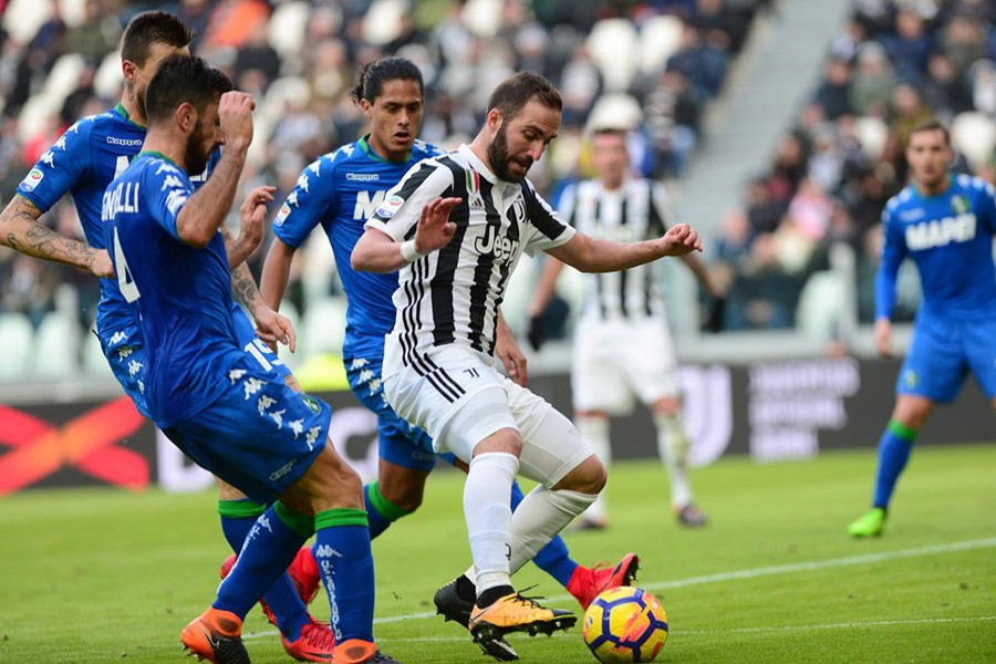 Juventus’ Gonzalo Higuain in action with Sassuolo's players during Sunday's encounter. - Reuters