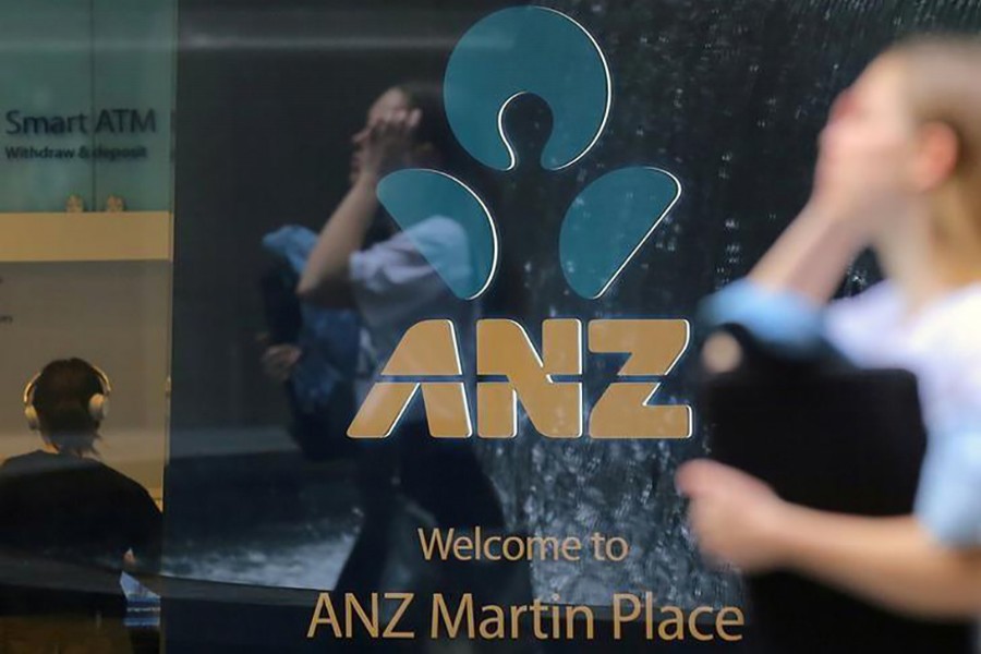 A pedestrian is reflected in the window of a branch of the Australia and New Zealand Banking Group (ANZ) in central Sydney, Australia on October 25, 2017. - Reuters file photo