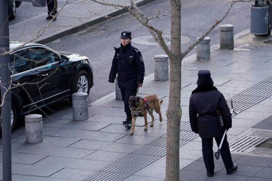 Police patrol outside the Joy City Mall in the Xidan district after a knife attack, in Beijing, China February 11, 2018.  - Reuters