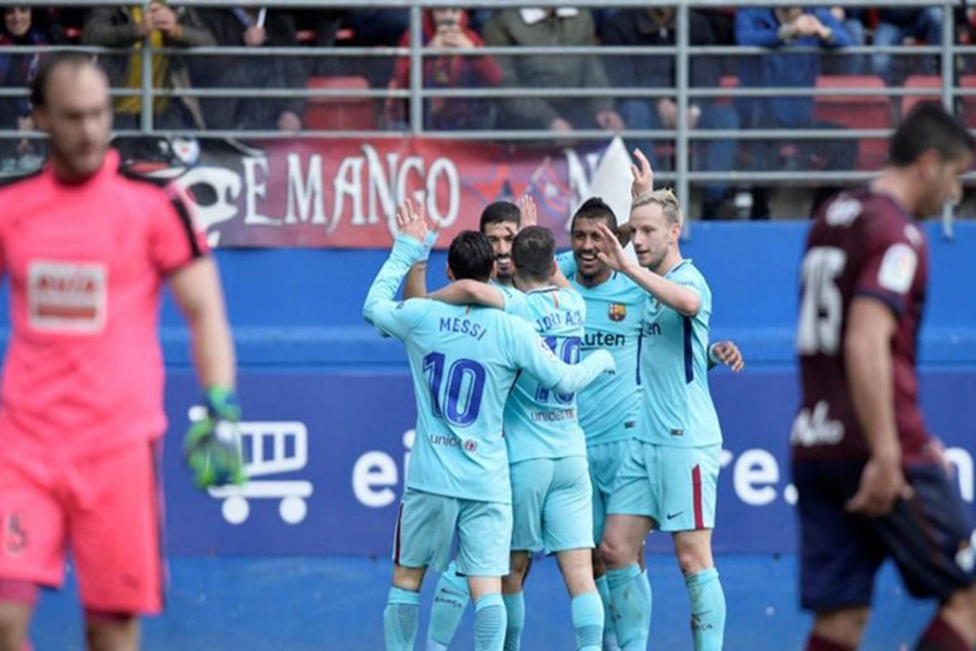 Barcelona’s Luis Suarez celebrates scoring their first goal with Lionel Messi and team mates. - Reuters photo