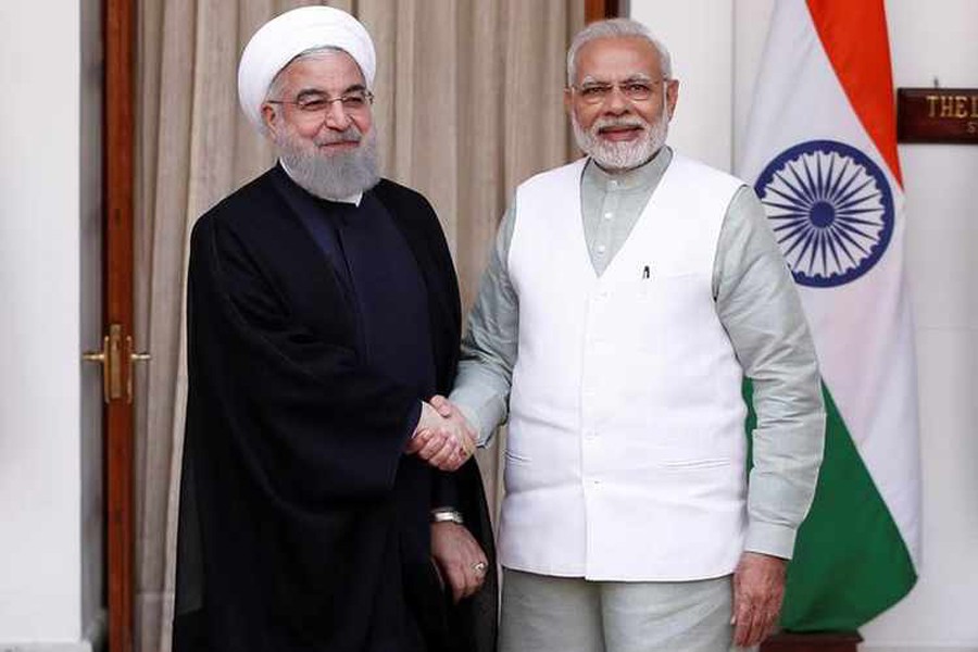 Iranian President Hassan Rouhani shakes hands with India's Prime Minister Narendra Modi (R) during a photo opportunity before their meeting at Hyderabad House in New Delhi, India Saturday. 	— Reuters