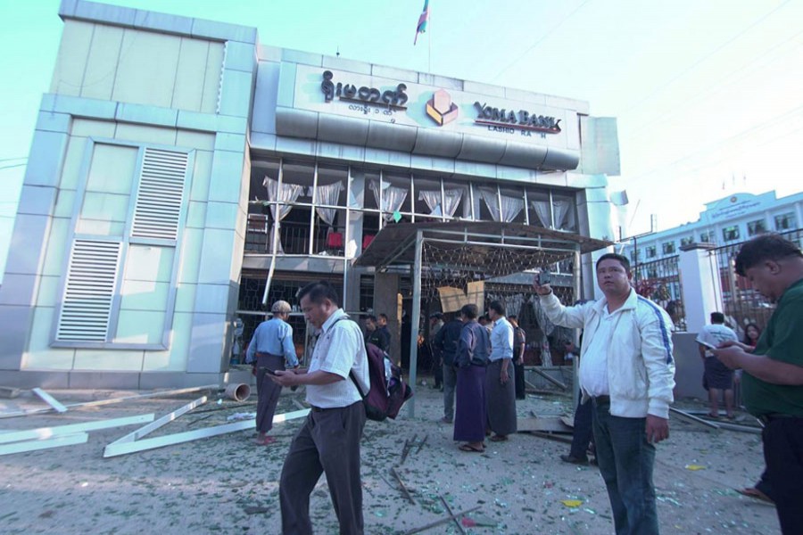 People inspect the damage at a bank after a bomb blast, in Lashio, Myanmar February 21, 2018 in this picture obtained from social media. Ministry of Information Webportal Myanmar/via Reuters