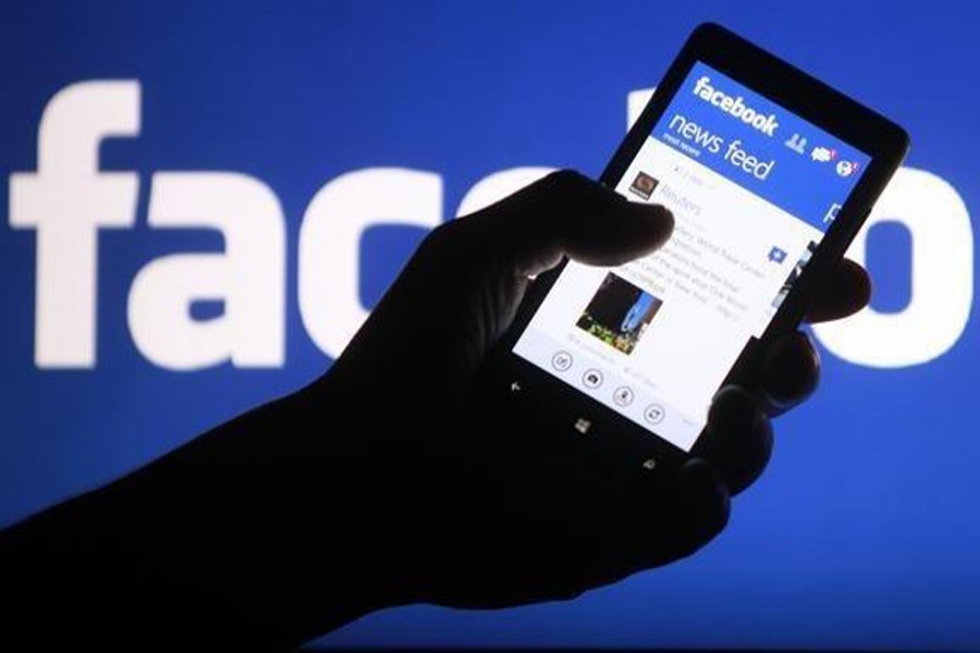 A smartphone user shows the Facebook application on his phone in the central Bosnian town of Zenica, May 2, 2013. Reuters/File Photo