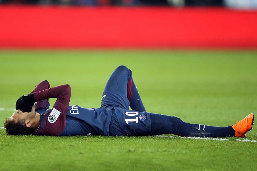 Paris Saint-Germain’s Neymar lies on the pitch after sustaining an injury  during their League 1 match against Marseille at the Parc des Princes on Sunday. - Reuters photo