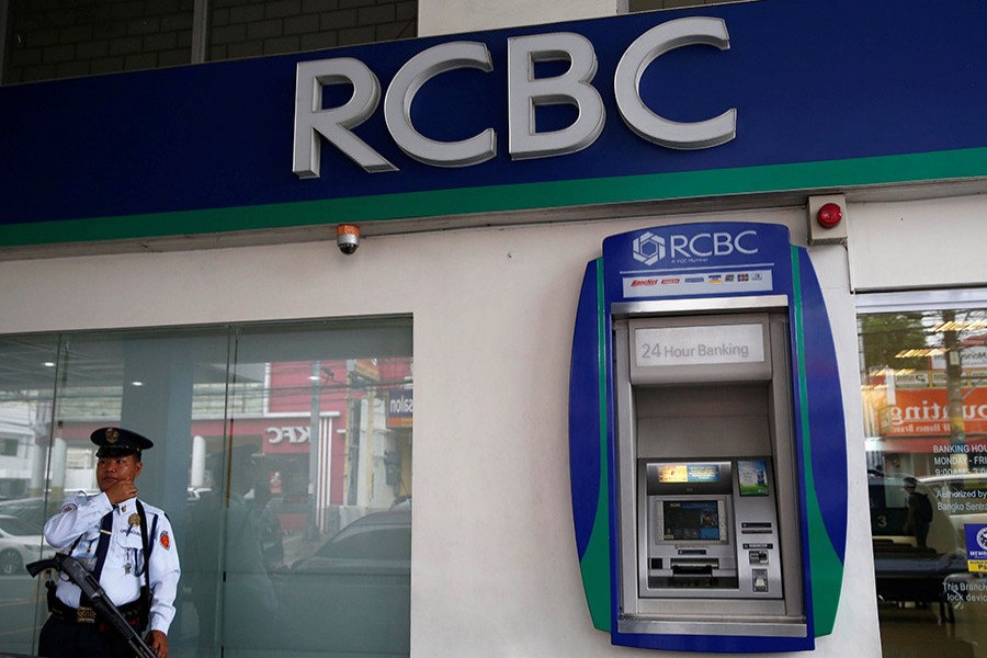 A security guard stands outside a branch of Rizal Commercial Banking Corporation in Paranaque City, Philippines. - Reuters file photo