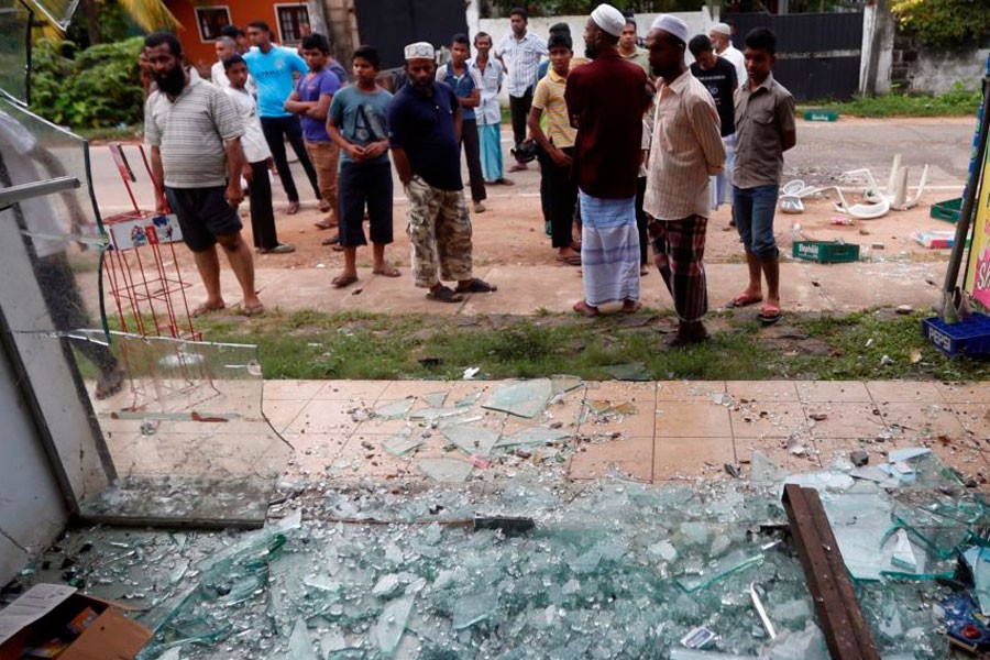 Muslims stand next to a burnt shop after a clash between Buddhists and Muslims in Aluthgama, Sri Lanka, June 16, 2014. Reuters file photo used for representational purpose.