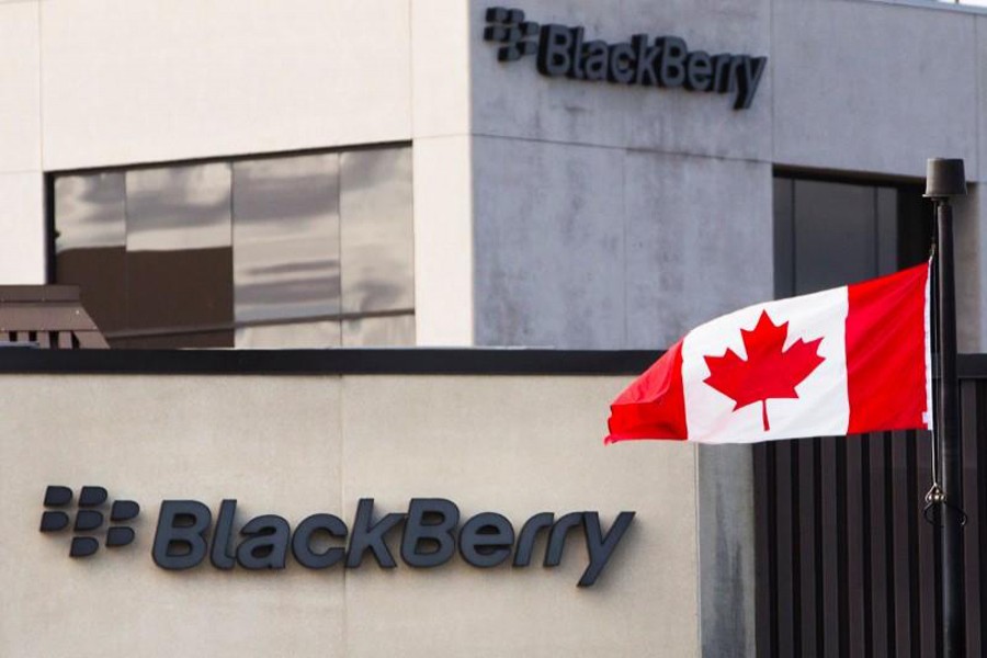 A Canadian flag waves in front of a Blackberry logo at the Blackberry campus in Waterloo, September 23, 2013. Reuters/File Photo