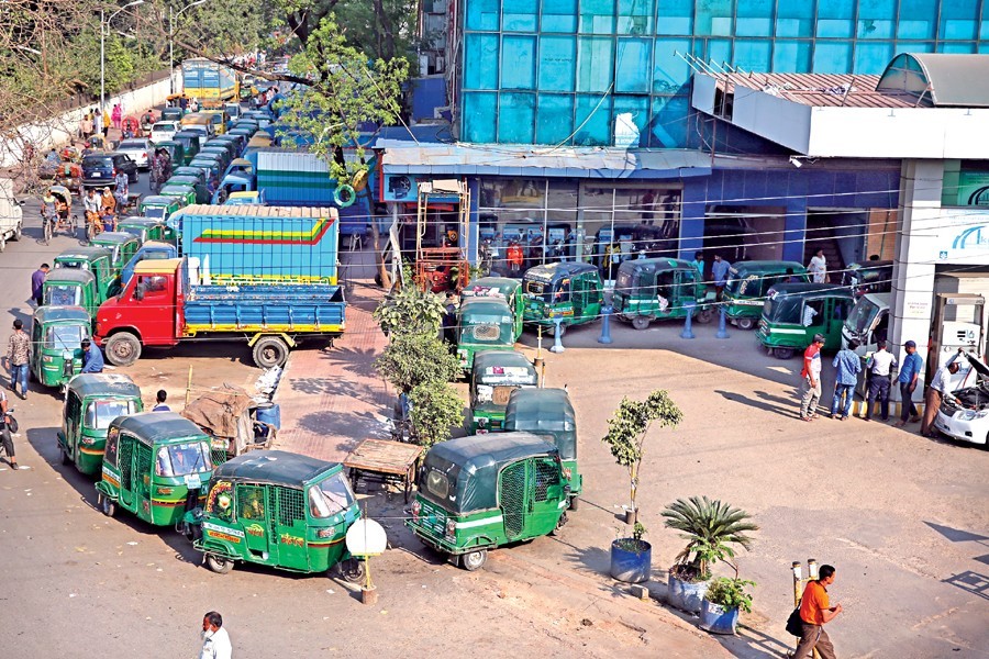 Vehicles waiting in a long queue due to low gas pressure at a CNG-refuelling station at Tejgaon in the capital. — FE Photo by KAZ Sumon