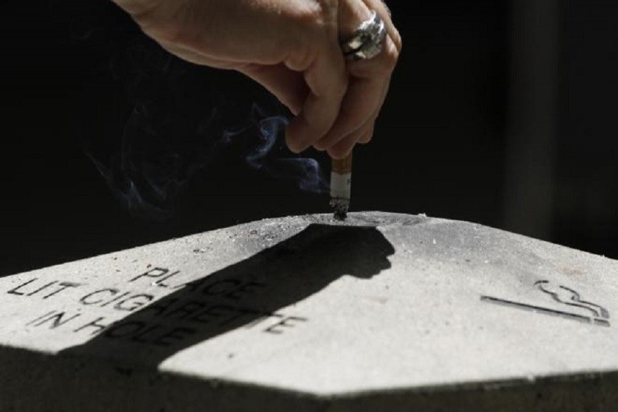 A woman disposes a cigarette in Los Angeles, California, May 31, 2012. Reuters/Files