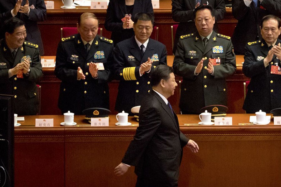 Military delegates applaud as Chinese President Xi Jinping arrives during a plenary meeting of China's National People's Congress (NPC) at the Great Hall of the People in Beijing on Sunday - AP photo