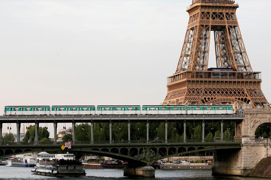 An elevated Paris Metro passes over a bridge next to the Eiffel Tower in Paris, France June 15, 2017. Reuters/File Photo