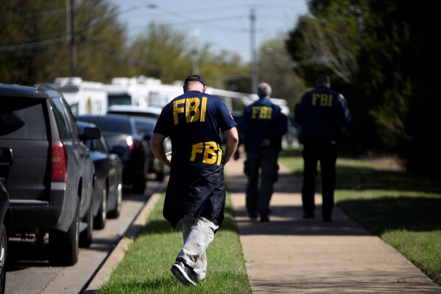 FBI agents walk towards a crime scene on Mission Oaks Boulevard following an explosion in Austin, Texas, US on March 19. Reuters/File Photo