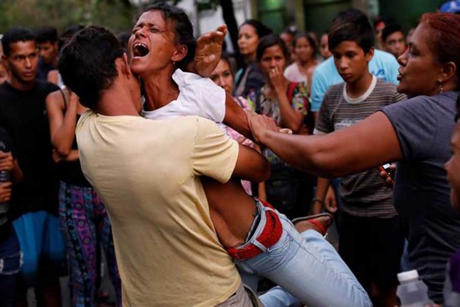 Relatives of inmates held at the General Command of the Carabobo Police react as they wait outside the prison, where a fire occurred in the cells area, according to local media, in Valencia, Venezuela March 28, 2018. - Reuters