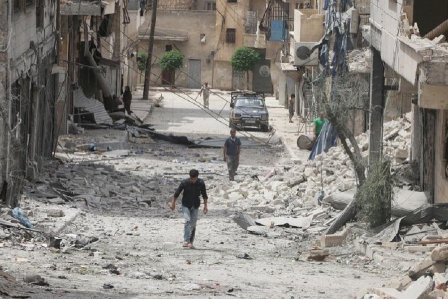 Representational image: People walk on the rubble of damaged buildings after an airstrike in the rebel held area of Aleppo's Baedeen district, Syria, May 3, 2016. Reuters/FIles