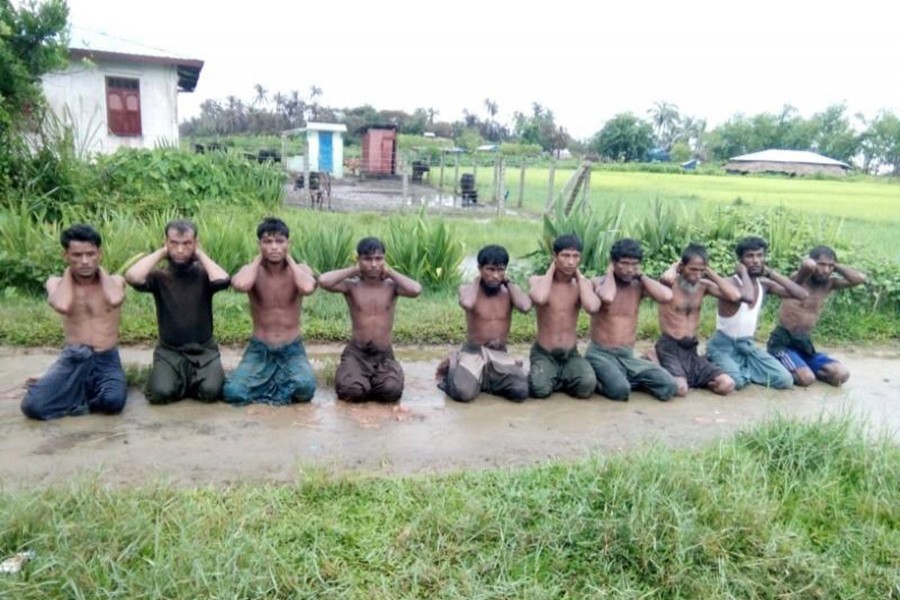 Ten Rohingya Muslim men with their hands bound kneel in Inn Din village on September 1, 2017 - Reuters file photo