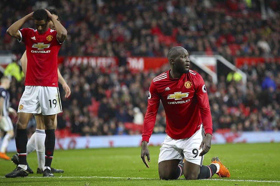 Manchester United players cut dejected figures after the shock loss to West Brom, which hands City the title - AP photo