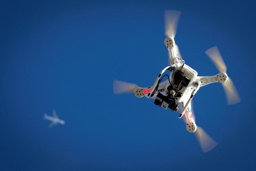 An airplane flies over a drone during the Polar Bear Plunge on Coney Island in the Brooklyn borough of New York, US, January 1, 2015. Reuters/File Photo