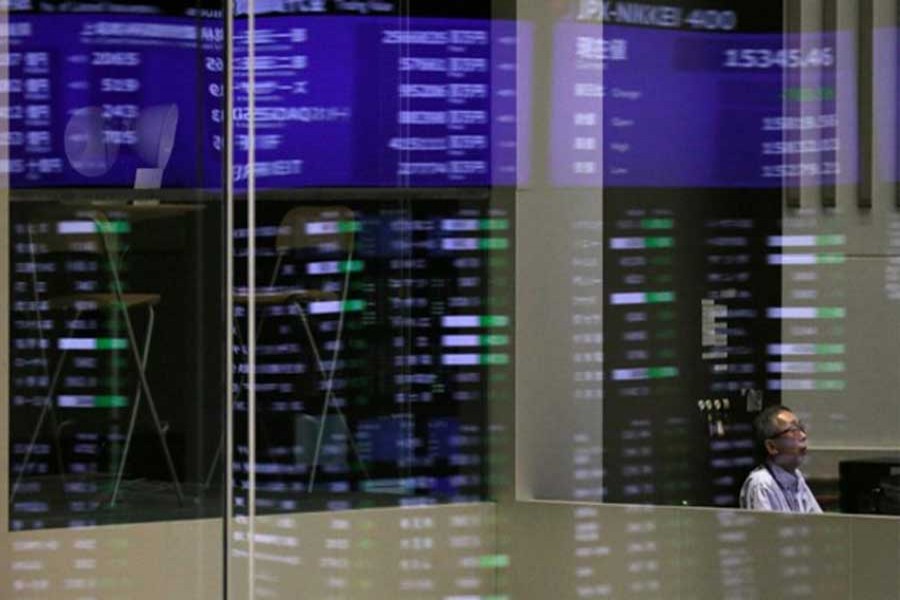 Market prices are reflected in a glass window at the Tokyo Stock Exchange in Tokyo, Japan, February 6, 2018. Reuters/Files