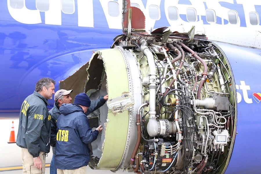 Investigators examine the damaged engine of Southwest Airlines flight WN1380 which was en route to Dallas from New York on Tuesday last - Reuters photo