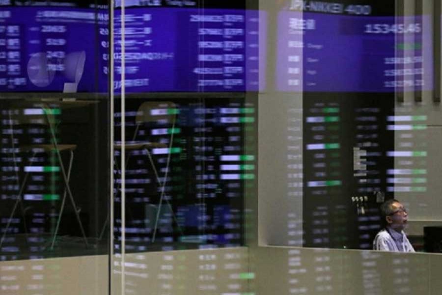 Market prices are reflected in a glass window at the Tokyo Stock Exchange (TSE) in Tokyo, Japan, February 6, 2018. Reuters/Files