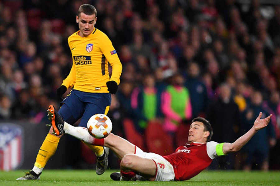 Atletico Madrid's Antoine Griezmann (left) in action with Arsenal's Laurent Koscielny during their first leg Europa League semi-final - Reuters photo