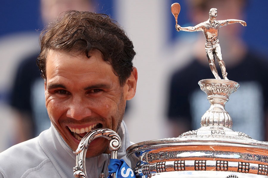 Nadal takes his customary bite out of the Barcelona Open trophy - Reuters photo