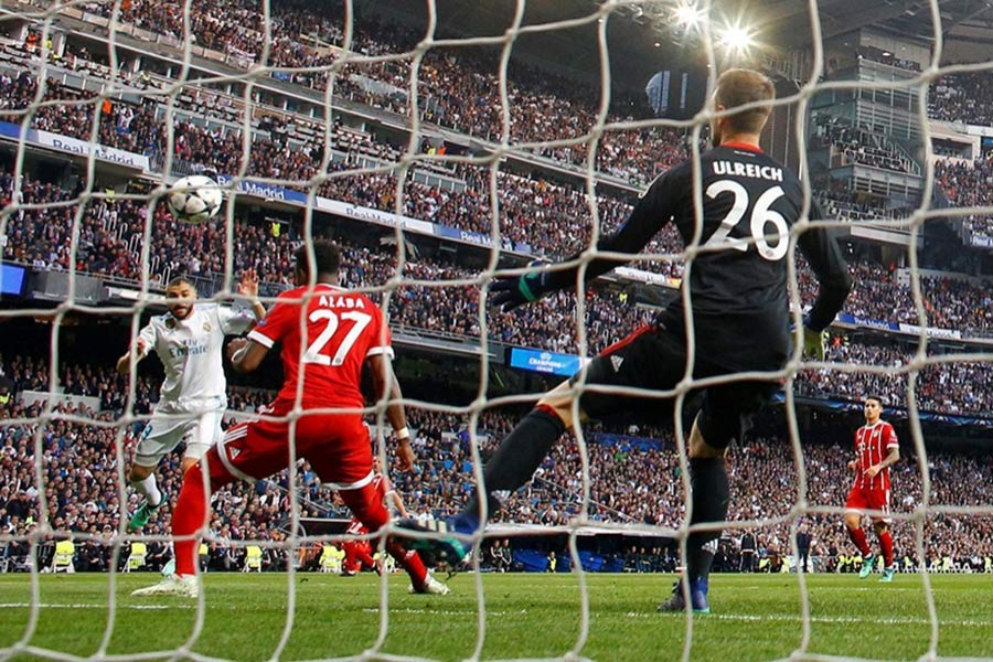 Karim Benzema heads the ball home against Bayern Munich at the Santiago Bernabeu - Reuters photo