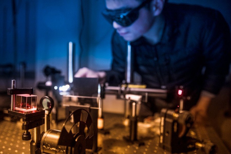 Shengwei Jiang, postdoctoral researcher, aligns an optical setup for magneto-optical Kerr rotation microscopy measurements on atomically thin magnets. Photo: Phys.org