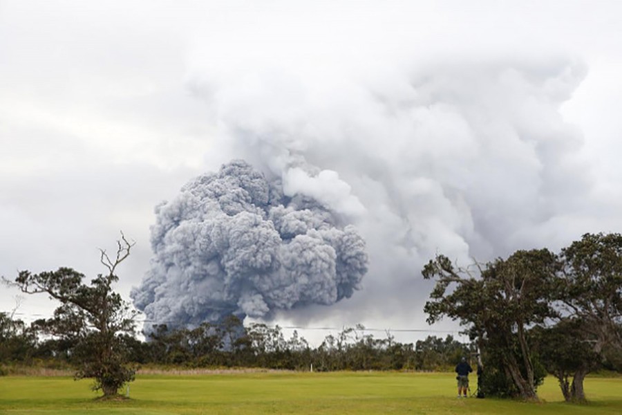 People watch as ash erupts from the Halemaumau crater near the community of Volcano during ongoing eruptions of the Kilauea Volcano in Hawaii, US on Tuesday - Reuters photo