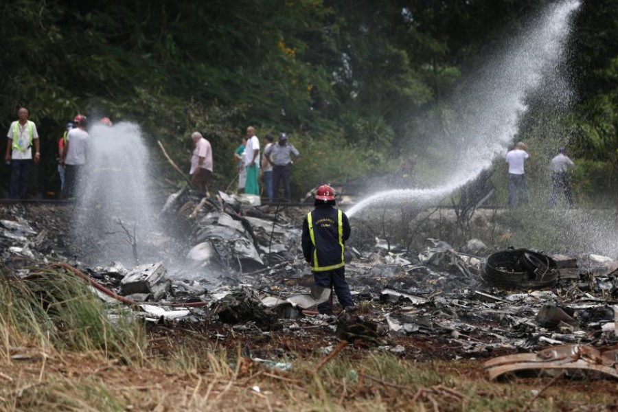 Firefighters work in the wreckage of a Boeing 737 plane that crashed in the agricultural area of Boyeros, around 20 km (12 miles) south of Havana, shortly after taking off from Havana's main airport in Cuba, May 18, 2018. Reuters.