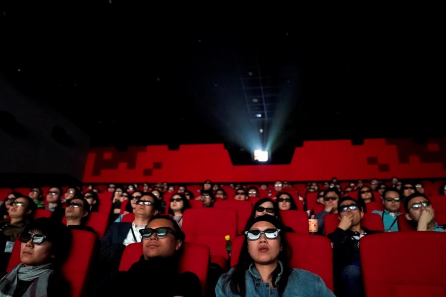 People watch a movie at a cinema in Wanda Group's Oriental Movie Metropolis ahead of its opening, in Qingdao, Shandong province, China April 27, 2018. Reuters/File Photo