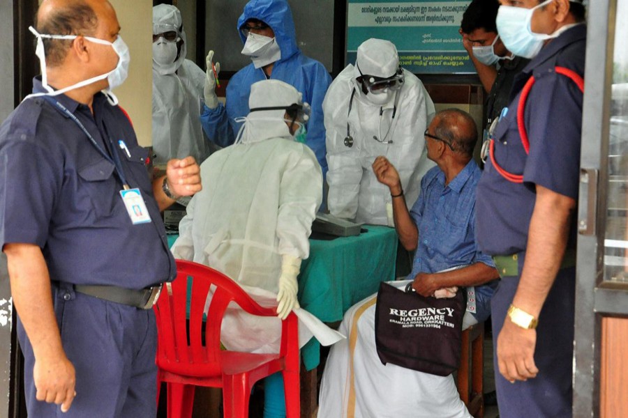 Medics wearing protective gear examine a patient at a hospital in Kozhikode in the southern state of Kerala, India May 21. Reuters/File