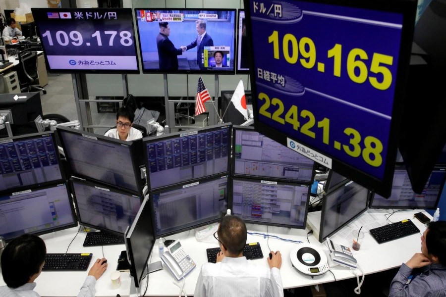 Monitors showing TV programme on the inter-Korean summit (C top), the Japanese yen's exchange rate against the US dollar (top L and top of blue screen) and Japan's Nikkei share average (bottom of blue screen) are seen at a foreign exchange trading company in Tokyo, Japan, April 27, 2018. Reuters/File Photo