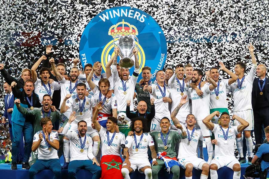 Real Madrid players and coaching staff celebrate winning the Champions League with the trophy - Reuters photo